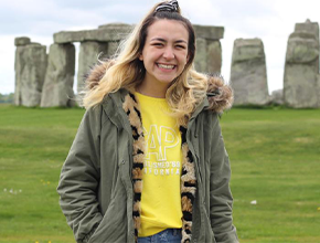 Person standing in front of Stonehenge